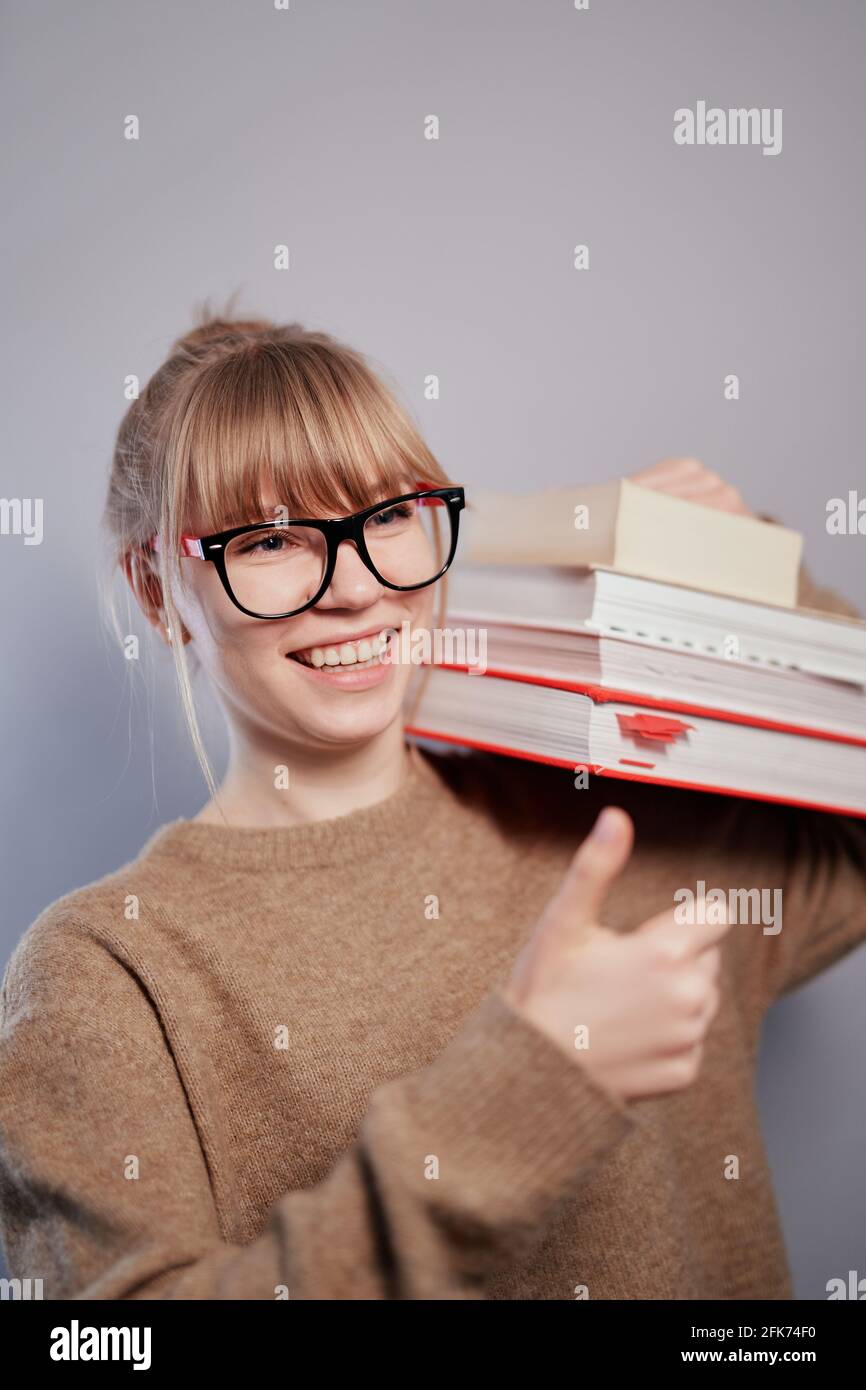 Students with thumbs up with books hi-res stock photography and images ...