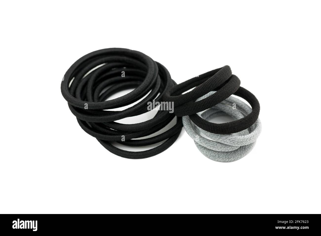 Pieces of hair elastics to tie hair. Rubber head dressing in Black Grey on white background Stock Photo