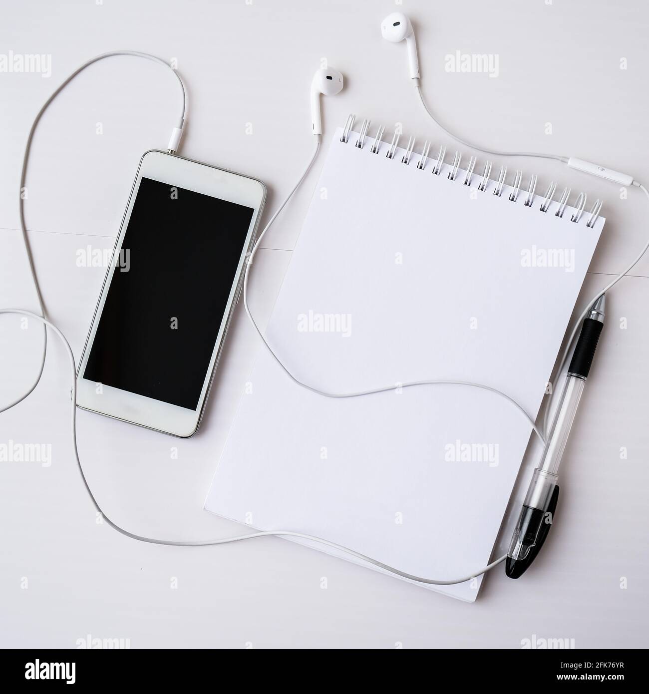 Notebook Open. Phone Open blank notebook with headphones mobile phone. Black screen and ...