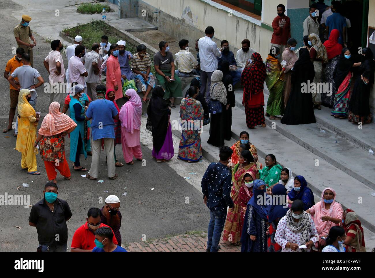 People wait to cast their votes outside a polling station during the eight and final phase of West Bengal state election, amid the spread of the coronavirus disease (COVID-19) in Kolkata, India, April 29, 2021. REUTERS/Rupak De Chowdhuri Stock Photo