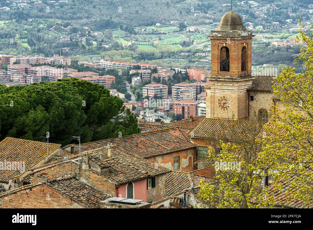 Urban landscape of the city of Perugia. Detail of the bell tower of the Santo Spirito church with the clock on one wall.   Perugia, Umbria, Italy Stock Photo