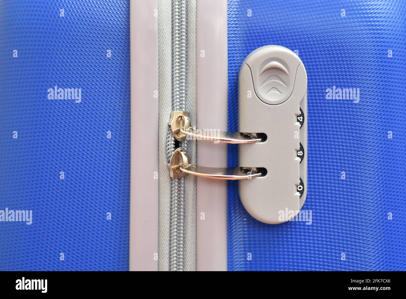 Combination lock close up on blue travel suitcase Stock Photo