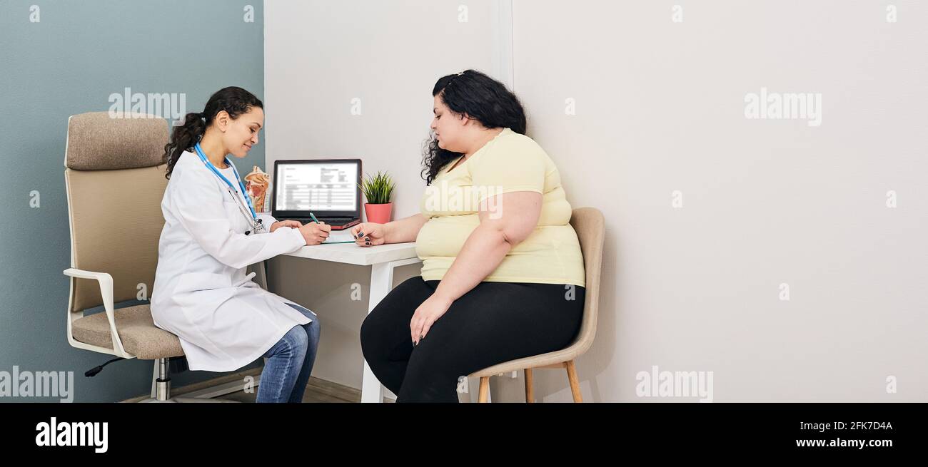 Dietitian consultation. Woman visits nutritionist for treatment obesity Stock Photo