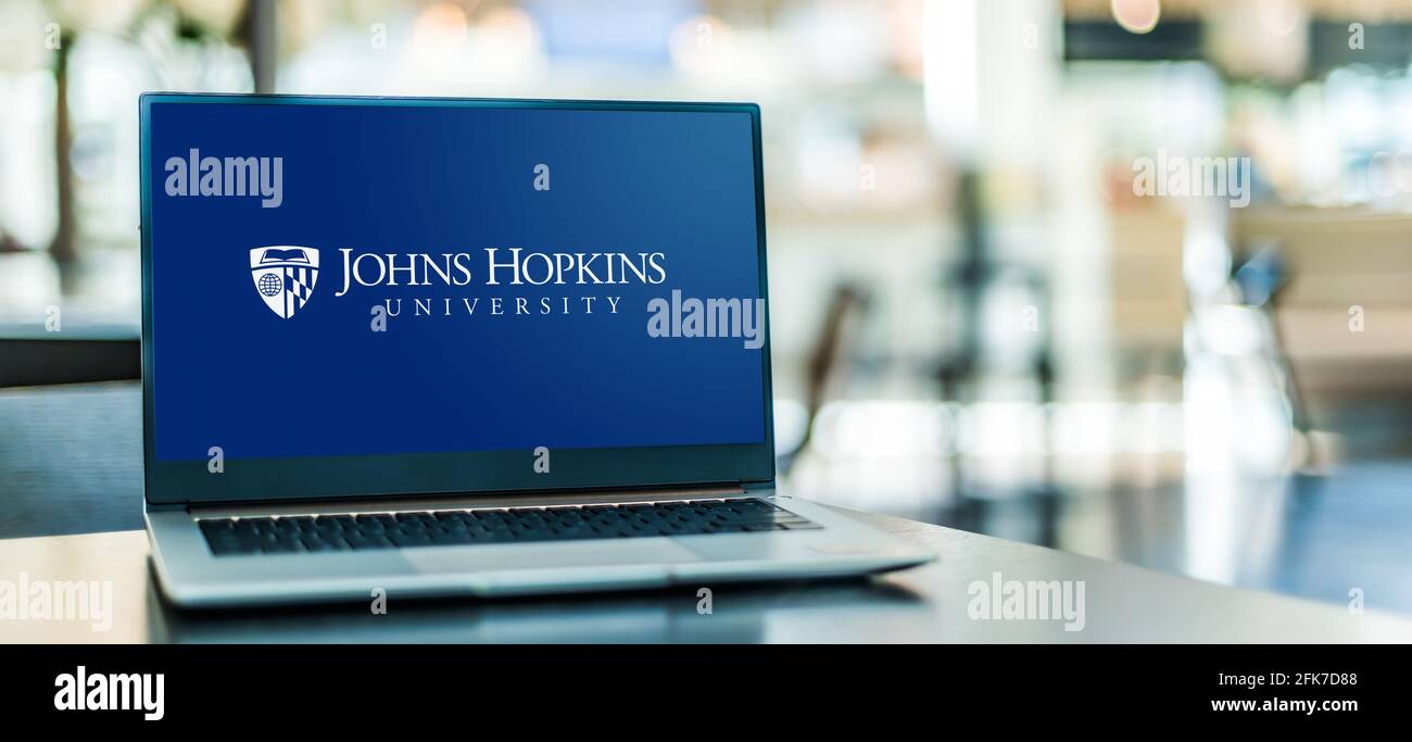 POZNAN, POL - APR 20, 2021: Laptop computer displaying logo of The Johns Hopkins University, a private research university in Baltimore, Maryland Stock Photo