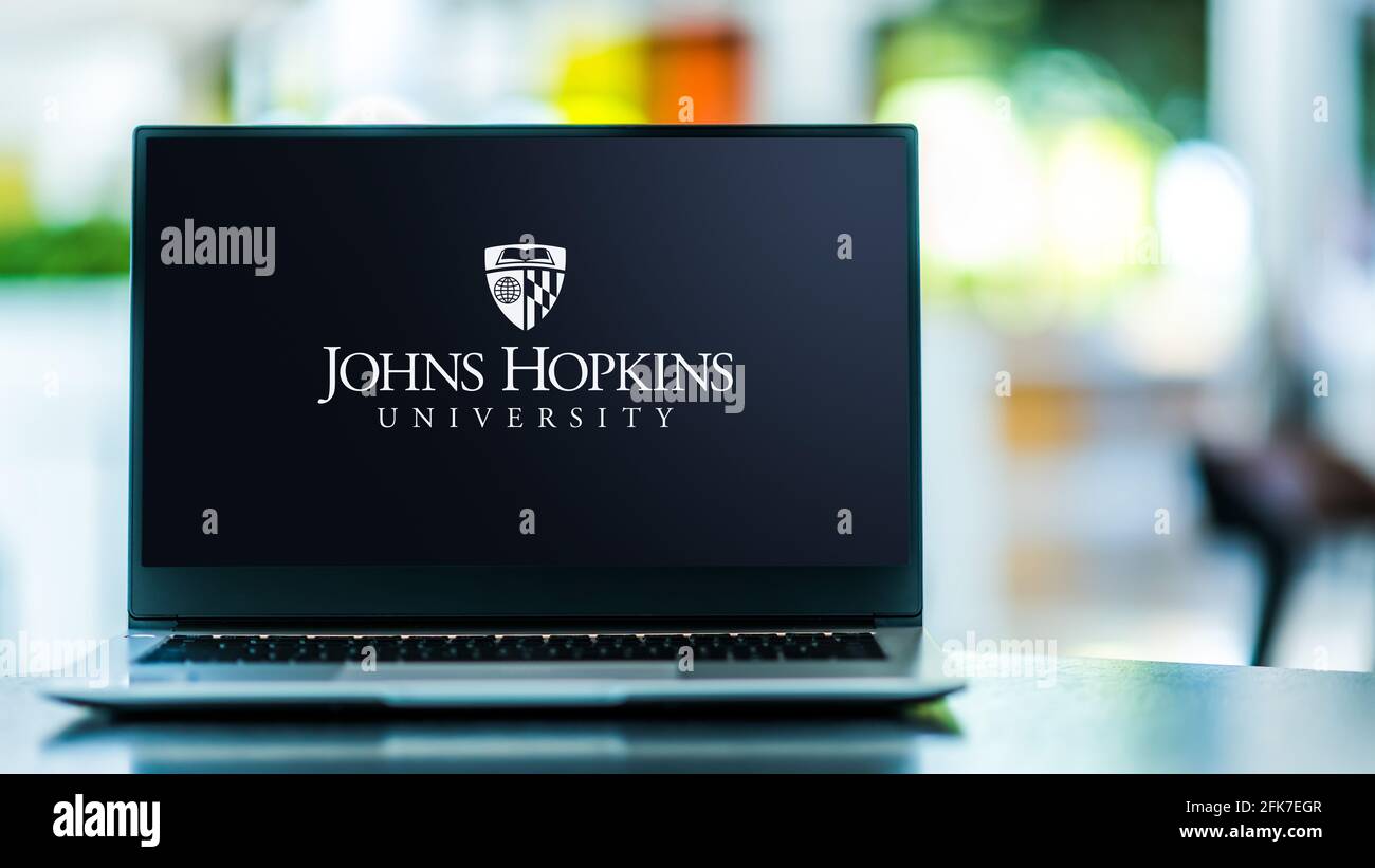 POZNAN, POL - APR 20, 2021: Laptop computer displaying logo of The Johns Hopkins University, a private research university in Baltimore, Maryland Stock Photo