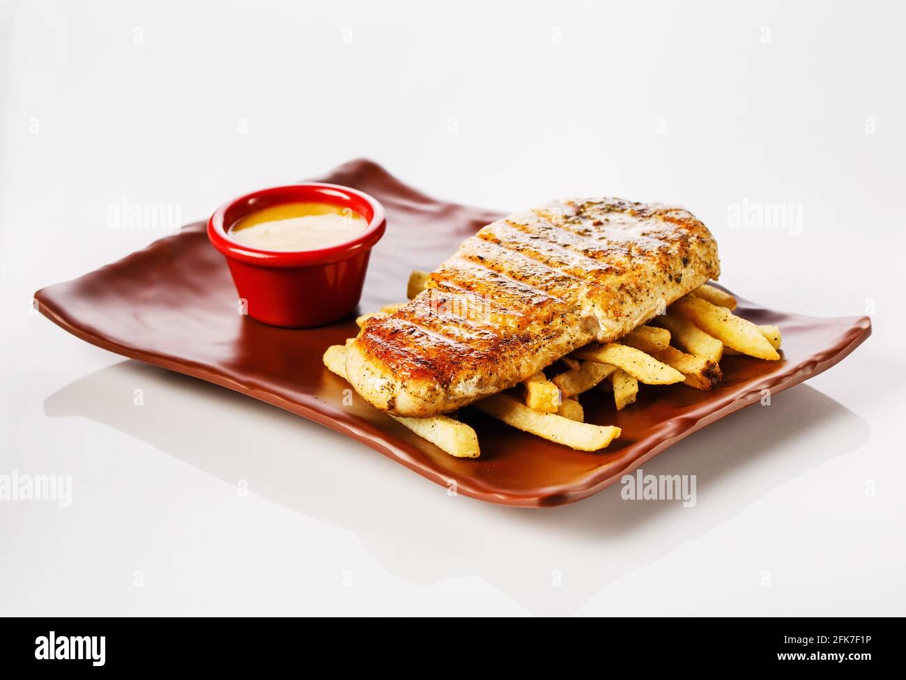 Chicken steak with french fries with honeymustard sauce Stock Photo