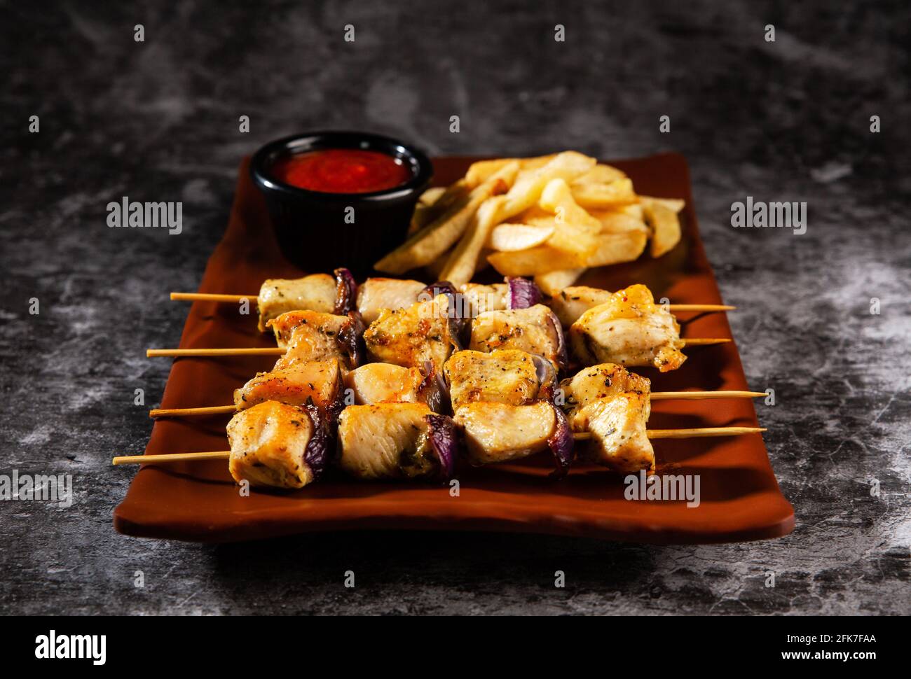 Chicken skewers. Pieces of tender chicken fillet, grilled with sweet onion rings Stock Photo