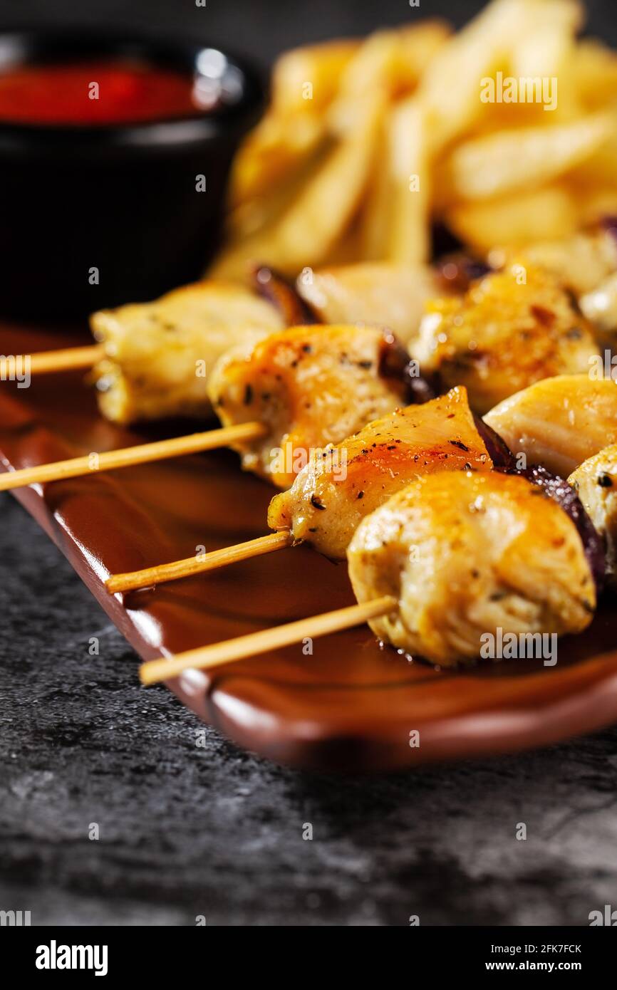 Chicken skewers. Pieces of tender chicken fillet, grilled with sweet onion rings Stock Photo