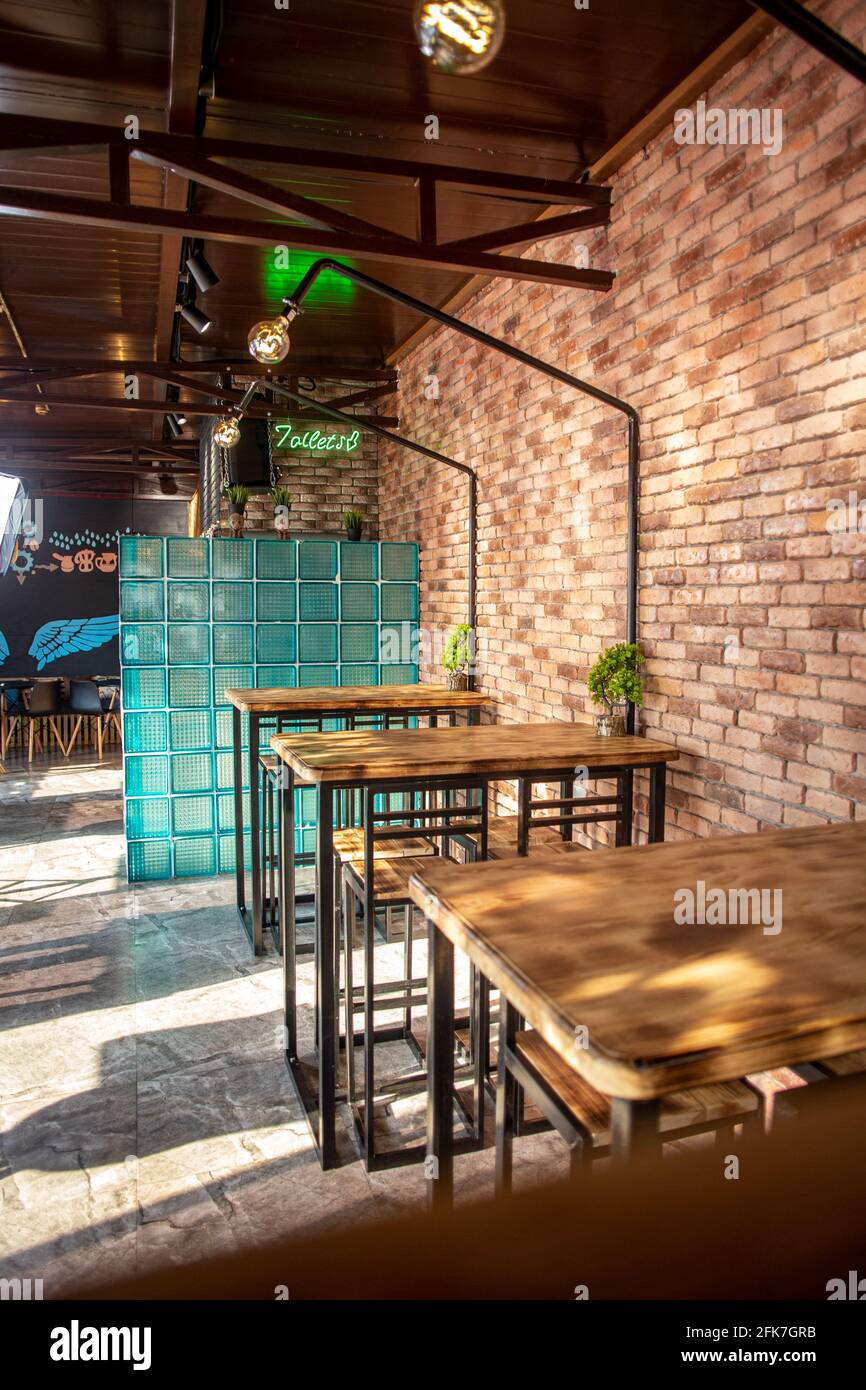 tables in a roadside cafe with a brick interior Stock Photo Alamy