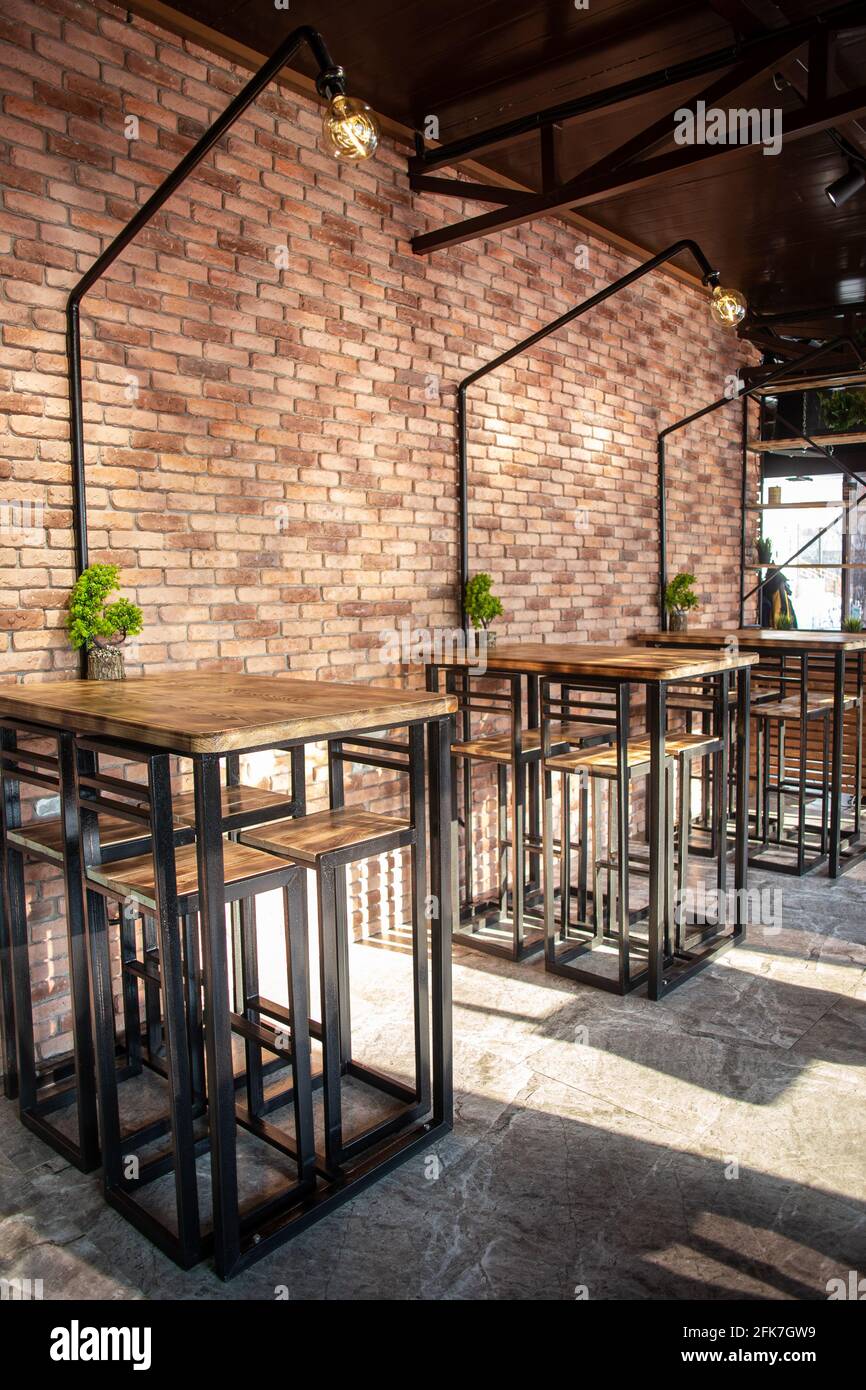 tables in a roadside cafe with a brick interior Stock Photo Alamy