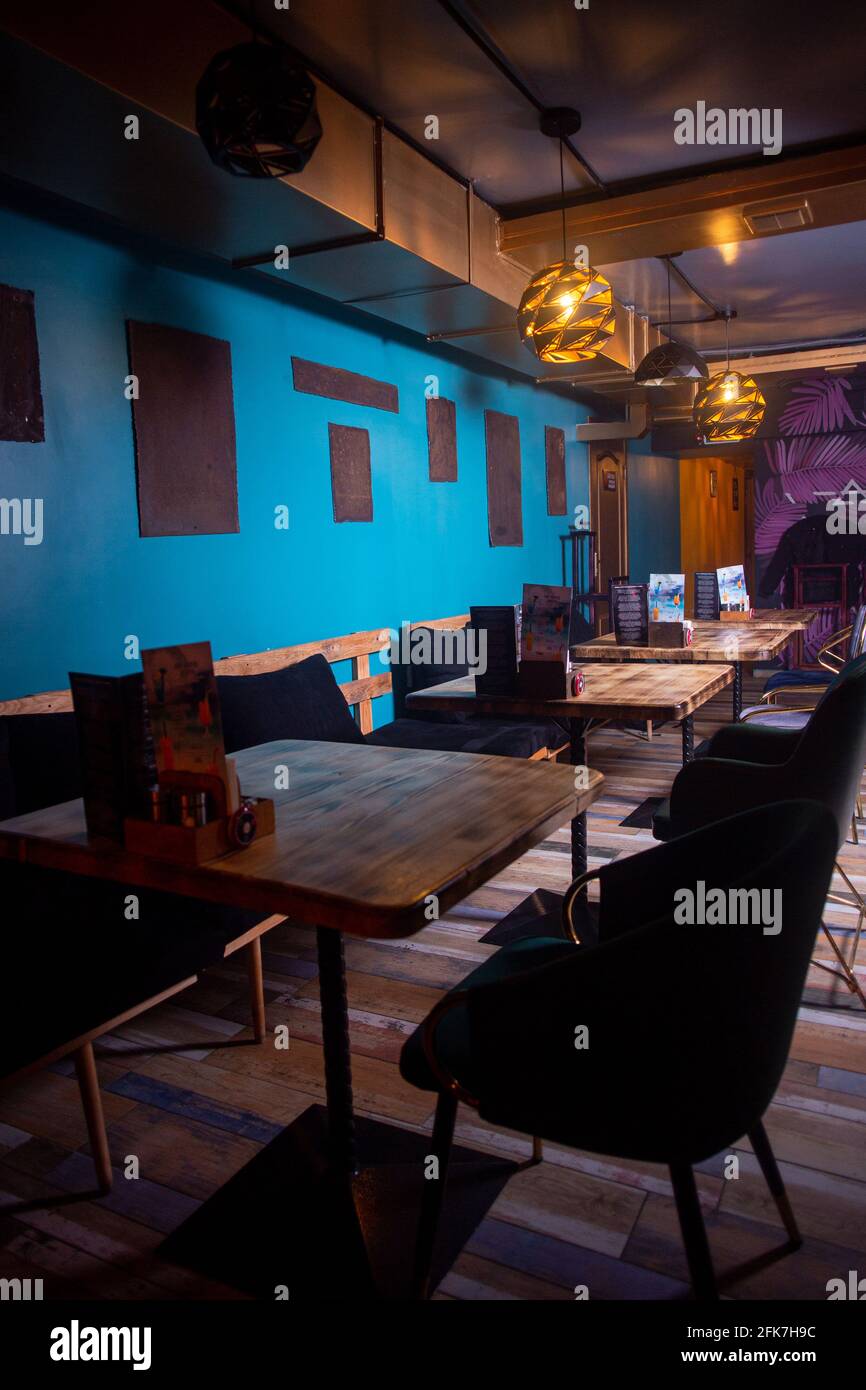 cafe interior with blue walls with black paintings Stock Photo - Alamy