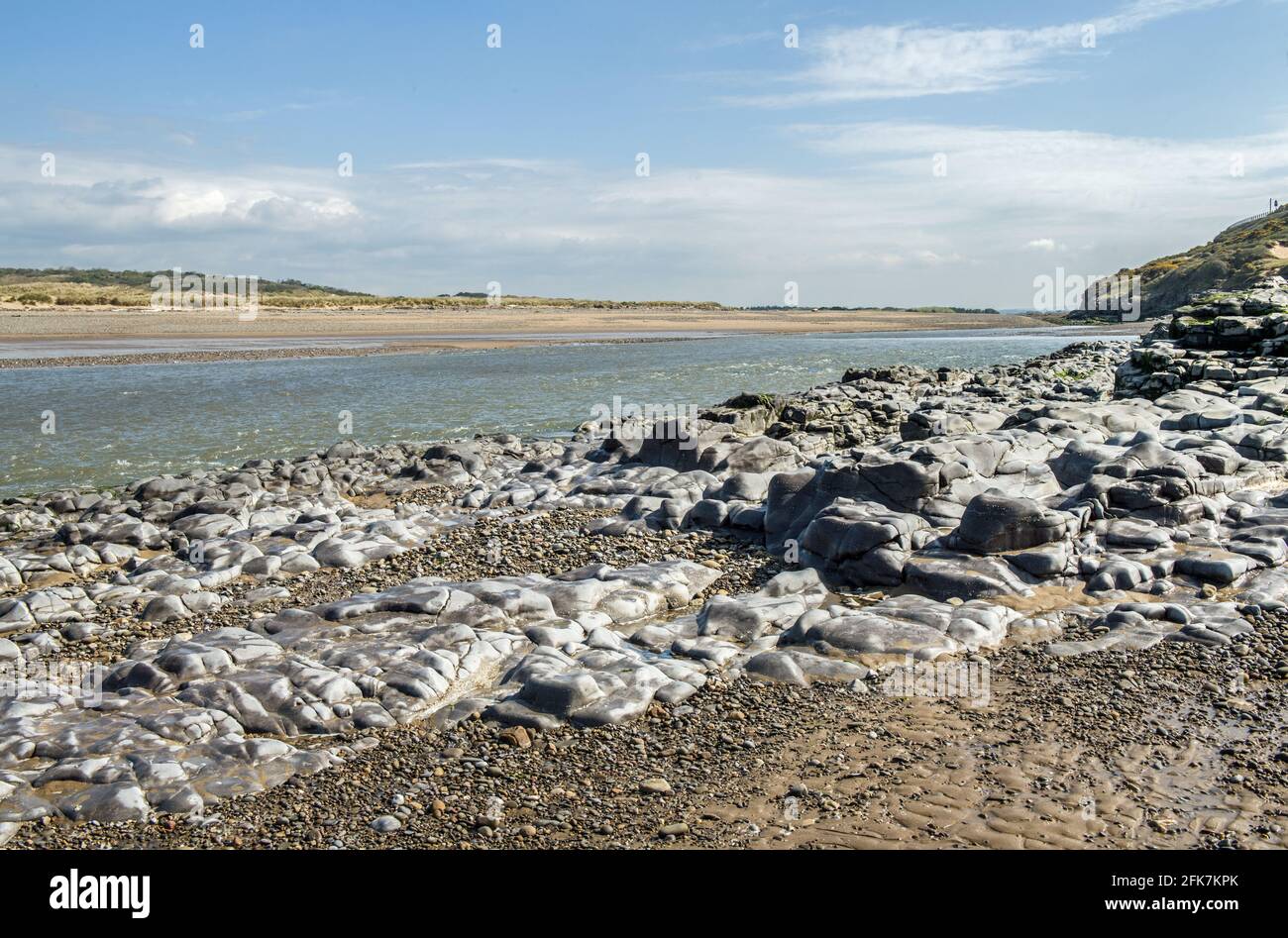 The estuary of the River Ogmore, or Afon Ogwr, where it empties out and fills up from the Bristol Channel at Ogmore by Sea South Wales Stock Photo