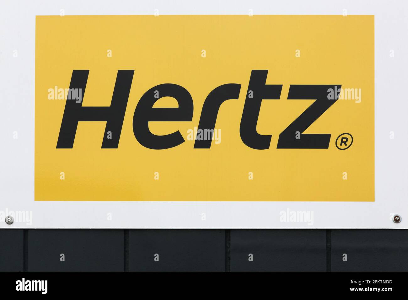 Billund, Denmark - February 20, 2019: Hertz logo on a wall. Hertz is an American car rental company with international locations Stock Photo