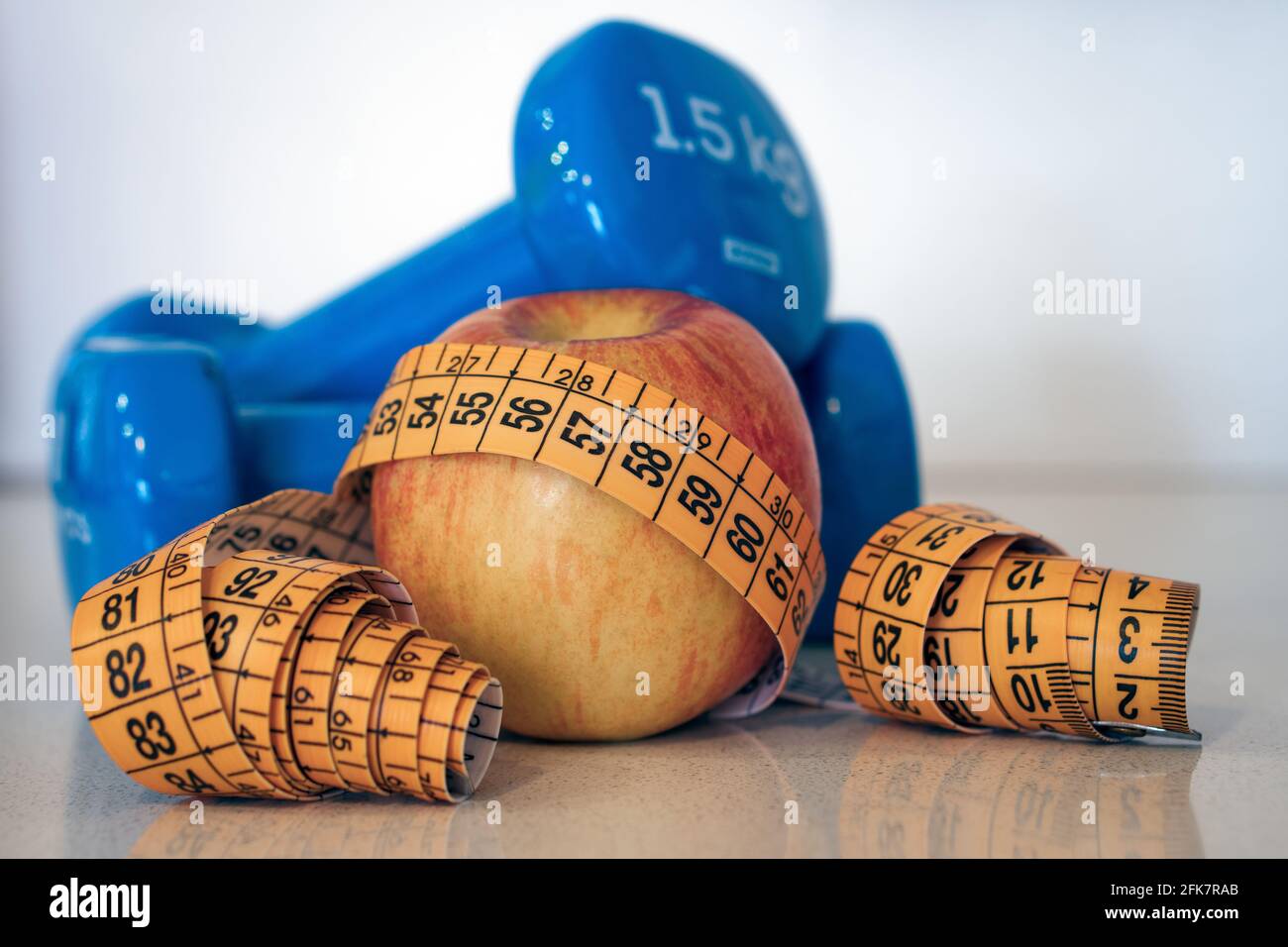 Apple with tape measure and dumbbells Stock Photo - Alamy