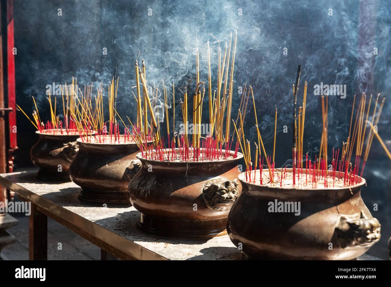 Burning red incense sticks in Chinese temple. Incense burning in a pot