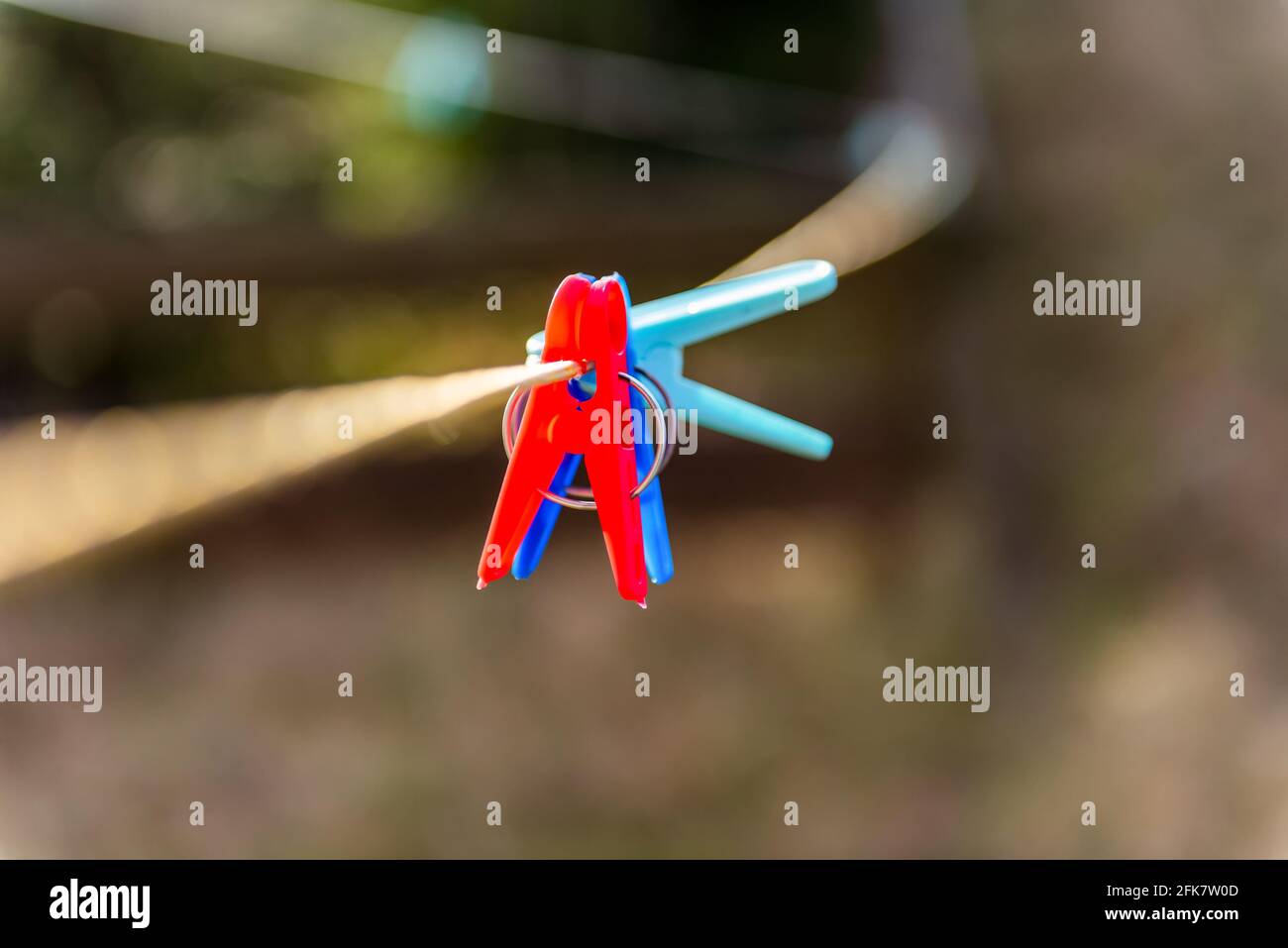 clothespins on a clothesline outdoor in courtyard of rural house. close