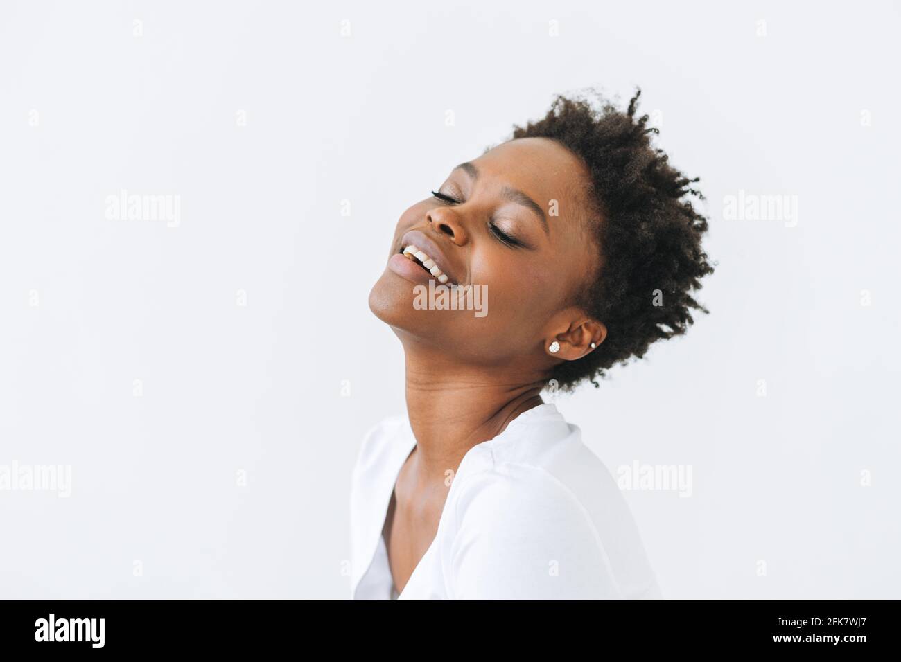 Portrait of beautiful happy young African American woman with close ...
