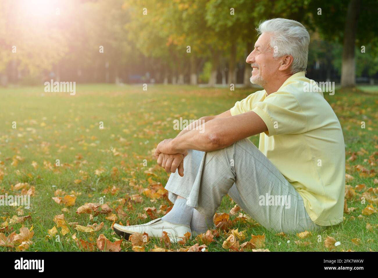 Older man sitting on grass hi-res stock photography and images - Alamy
