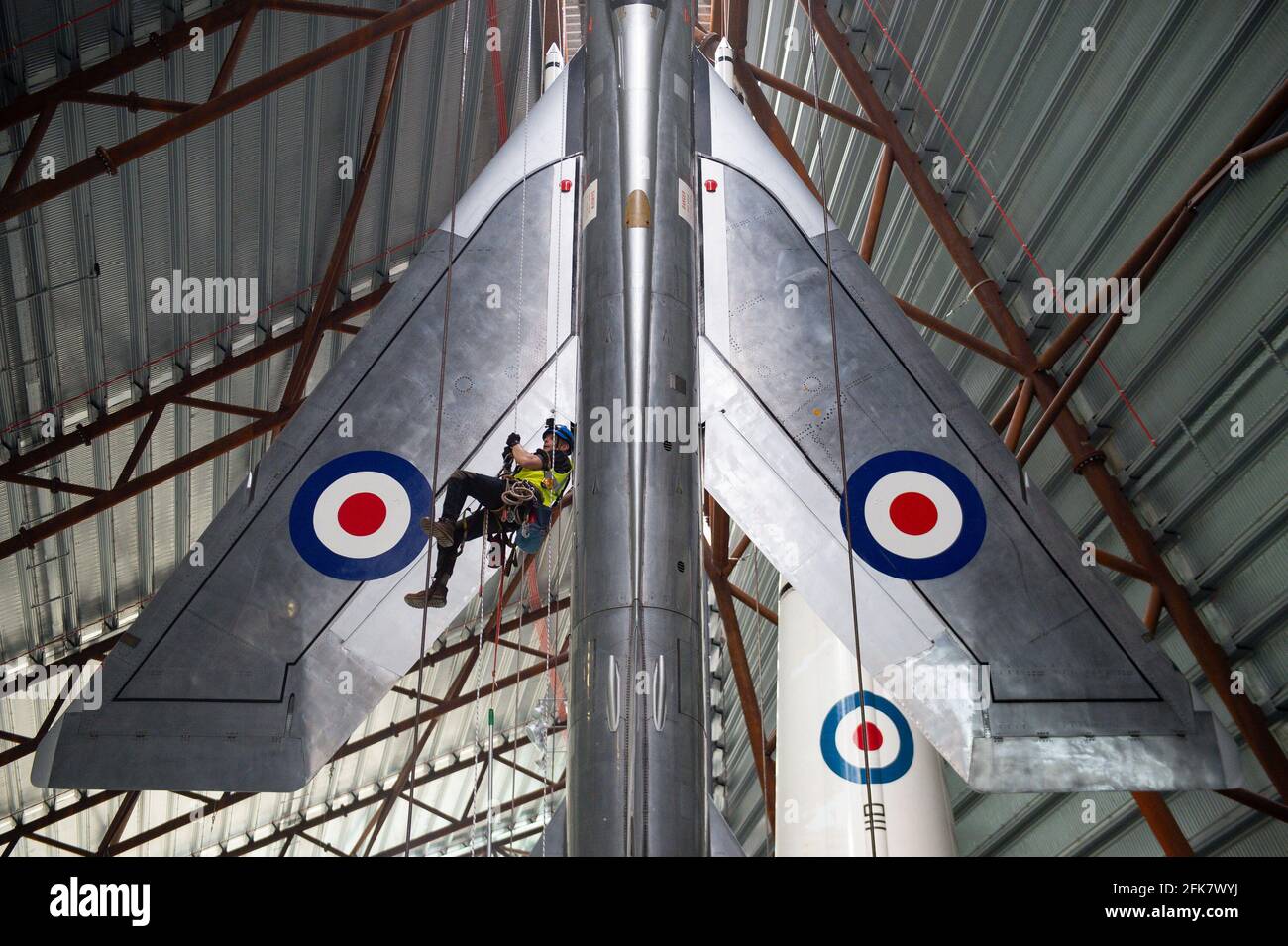 Specialist operators at the Royal Air Force Museum Cosford, near Telford, Shropshire, clean the Electric Lightning aircraft displayed within the museum's National Cold War Exhibition, during annual high-level aircraft cleaning and maintenance. Picture date: Thursday April 29, 2021. Stock Photo