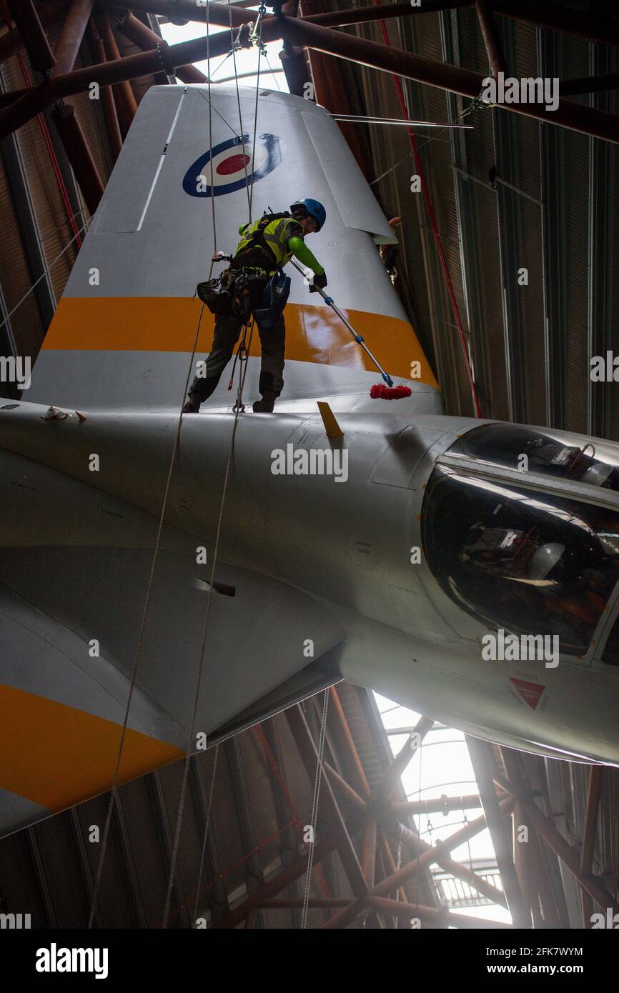 Specialist operators at the Royal Air Force Museum Cosford, near Telford, Shropshire, clean the Hawker Hunter aircraft displayed within the museum's National Cold War Exhibition, during annual high-level aircraft cleaning and maintenance. Picture date: Thursday April 29, 2021. Stock Photo