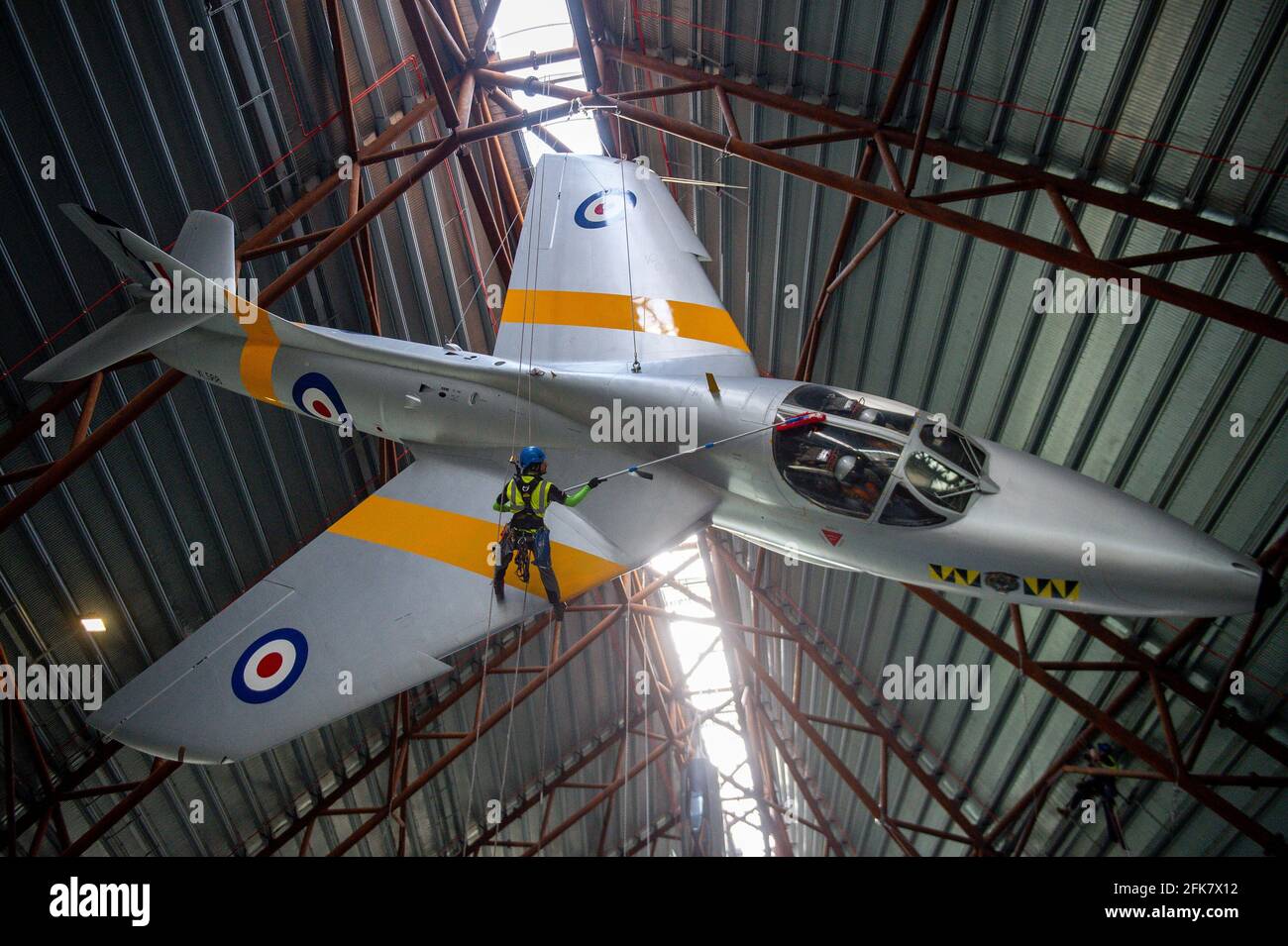 Specialist operators at the Royal Air Force Museum Cosford, near Telford, Shropshire, clean the Hawker Hunter aircraft displayed within the museum's National Cold War Exhibition, during annual high-level aircraft cleaning and maintenance. Picture date: Thursday April 29, 2021. Stock Photo