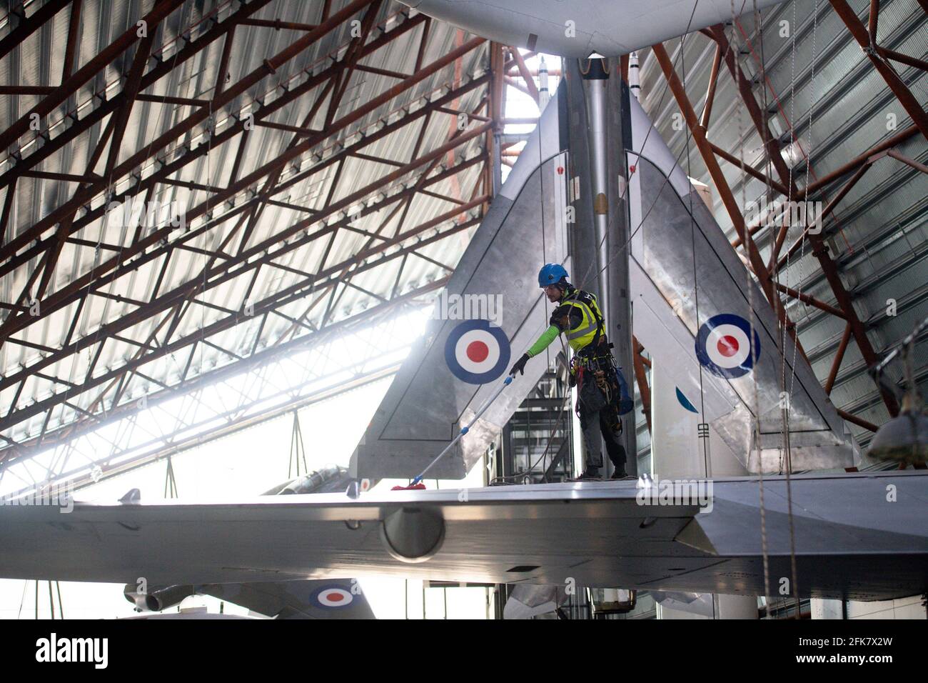 Specialist operators at the Royal Air Force Museum Cosford, near Telford, Shropshire, clean the Avro Vulcan aircraft displayed within the museum's National Cold War Exhibition, during annual high-level aircraft cleaning and maintenance. Picture date: Thursday April 29, 2021. Stock Photo