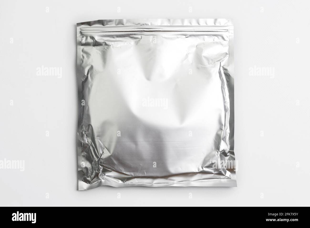 Foil bag package isolated on white background. Silver aluminium metallic  foil doypack, packaging pouch with zipper Stock Photo - Alamy