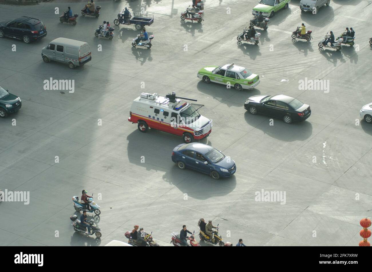 Security police in military vehicle control with a roof mounted cannon drive amongst other vehicles down a major road in the center of Kashgar in the South of  Xinjiang, China, PRC. © Time-Snaps Stock Photo