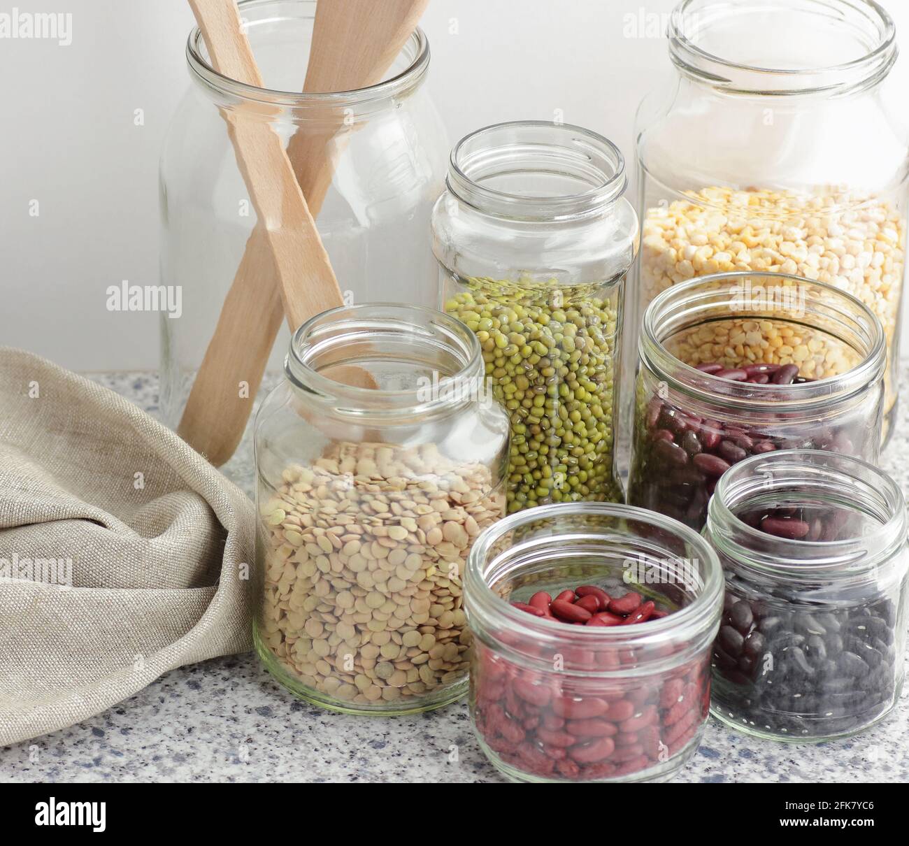 Variety of dry legumes kidney bean, peas, green gram in glass jars