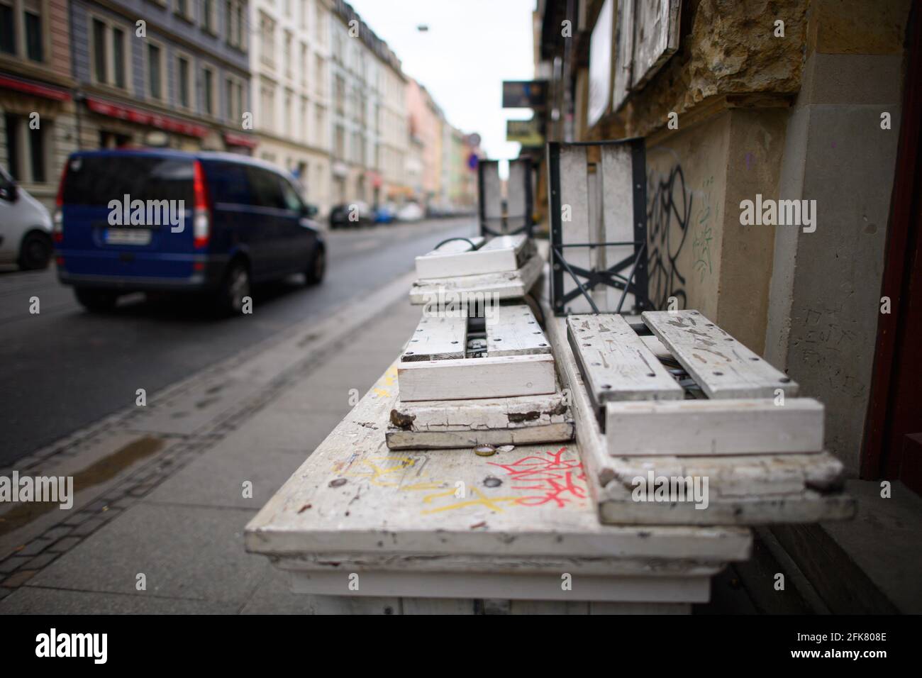 Dresden, Germany. 29th Apr, 2021. Beer benches are folded up on tables in front of a bar in the new town. Credit: Robert Michael/dpa-Zentralbild/dpa/Alamy Live News Stock Photo