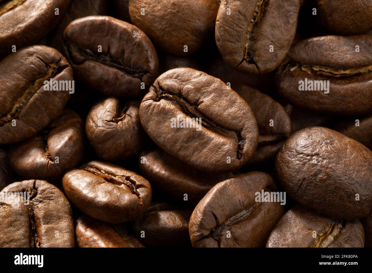 Brown roasted coffee beans close up full frame as a background Stock Photo