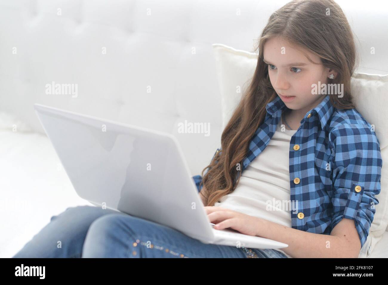 Cute girl with laptop sitting o the floor Stock Photo - Alamy