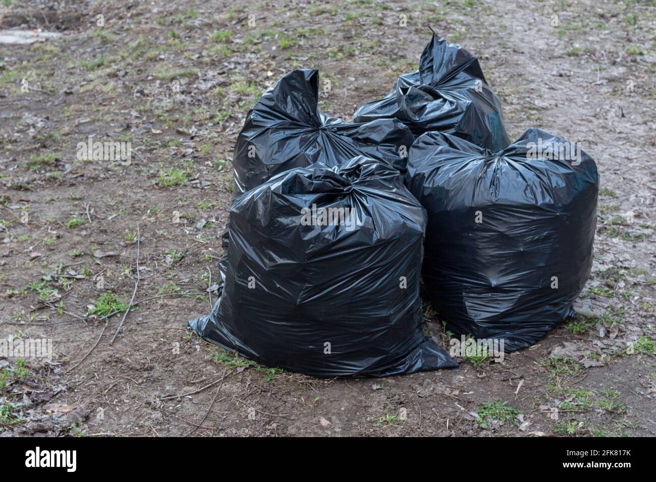 https://c8.alamy.com/comp/2FK817K/several-black-garbage-bags-on-the-ground-to-be-handed-over-to-the-garbage-collection-service-garbage-removal-on-the-city-streets-seasonal-cleaning-o-2FK817K.jpg