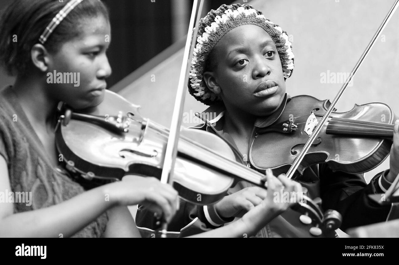 JOHANNESBURG, SOUTH AFRICA - Mar 13, 2021: Johannesburg, South Africa - August 28 2010: Diverse youth at music school orchestra Stock Photo