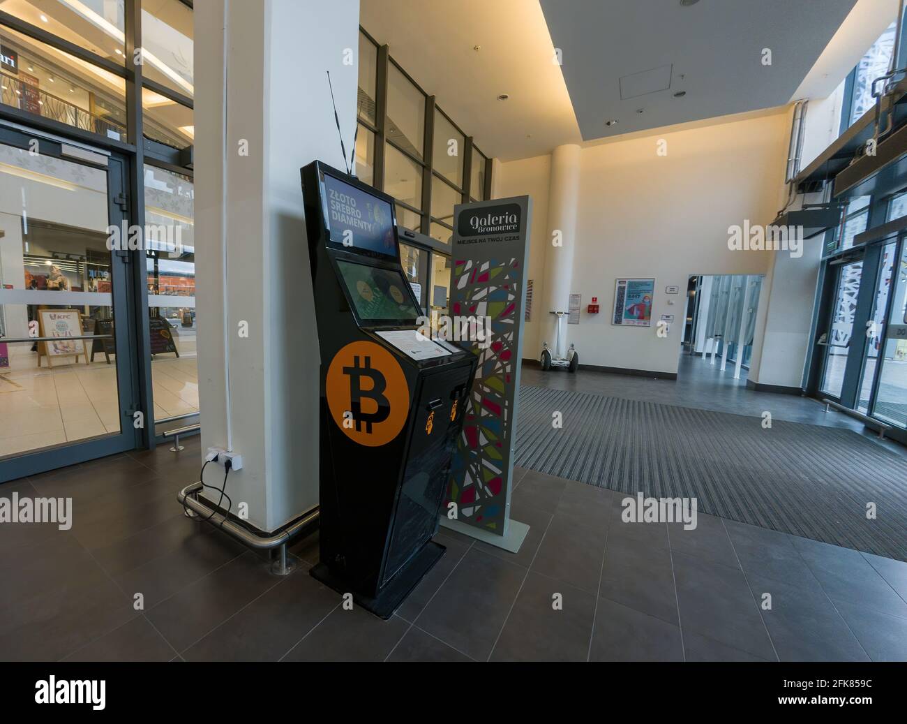 Krakow, Poland - April 28, 2021: Online currency Bitcoin vending machine cryptocurrency dispenser in shopping centre mall entrance, Europe Stock Photo