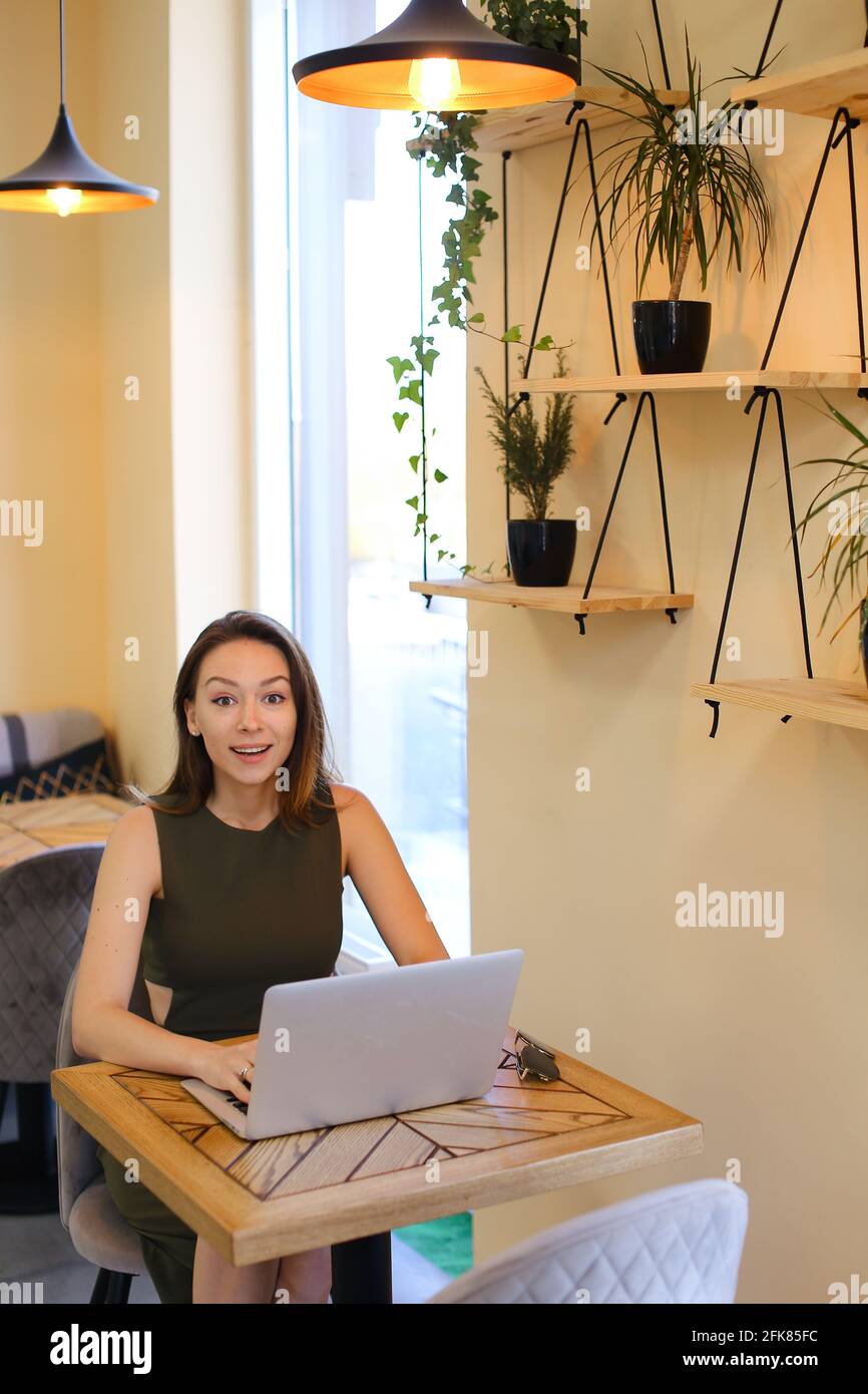 Young intelligent woman using laptop computer at cafe Stock Photo - Alamy