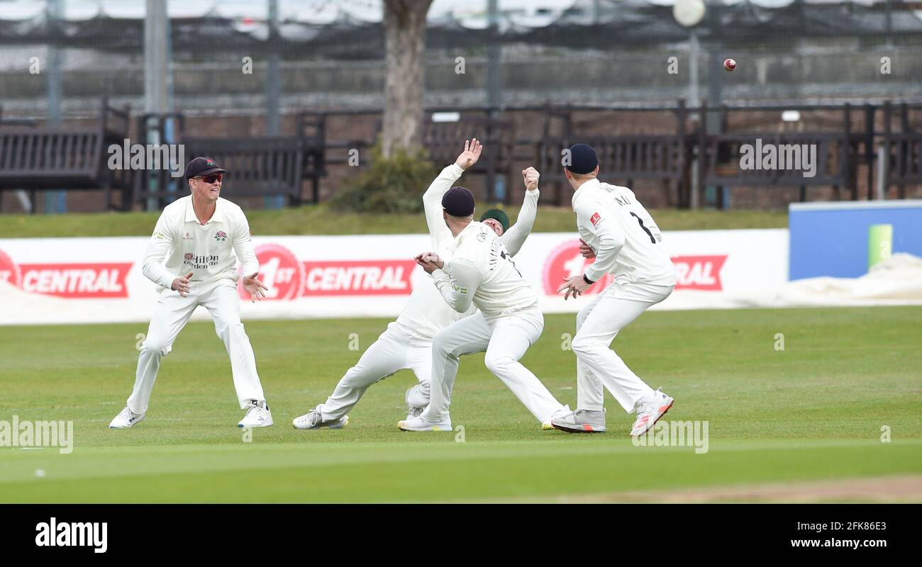 Hove UK 29th April 2021 - The ball flies past the Lancashire slip fielders including the diving Steven Croft against Sussex Lancashire on the first day of their LV= Insurance County Championship match at The 1st Central County Ground  in Hove . : Credit Simon Dack / Alamy Live News Stock Photo