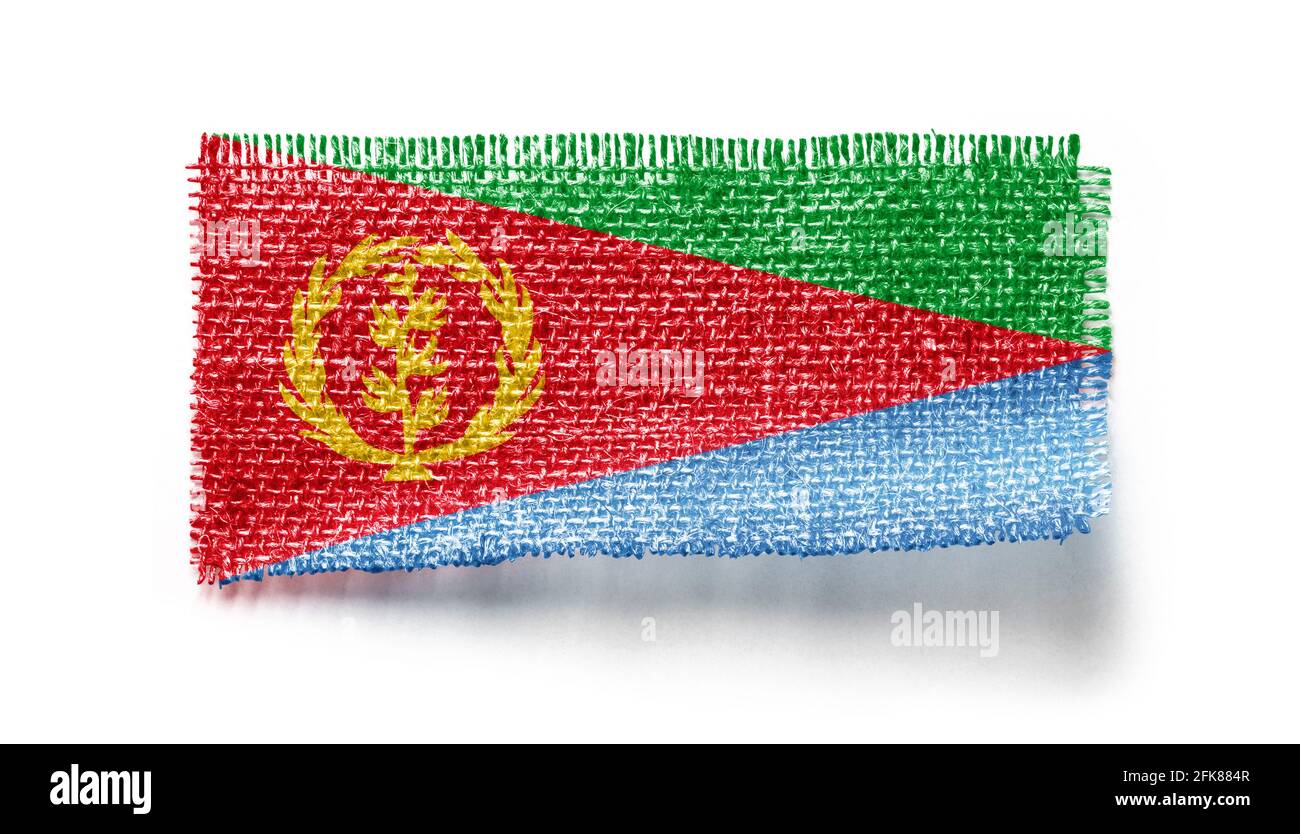 Eritrea flag on a piece of cloth on a white background Stock Photo - Alamy