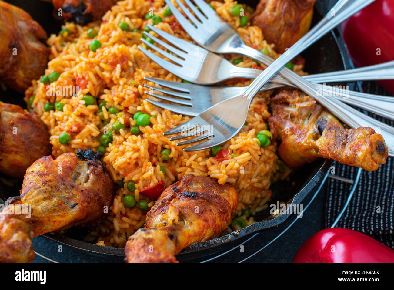 oven baked chicken drumsticks with spicy mediterranean djuvec rice served in a cast iron skillet