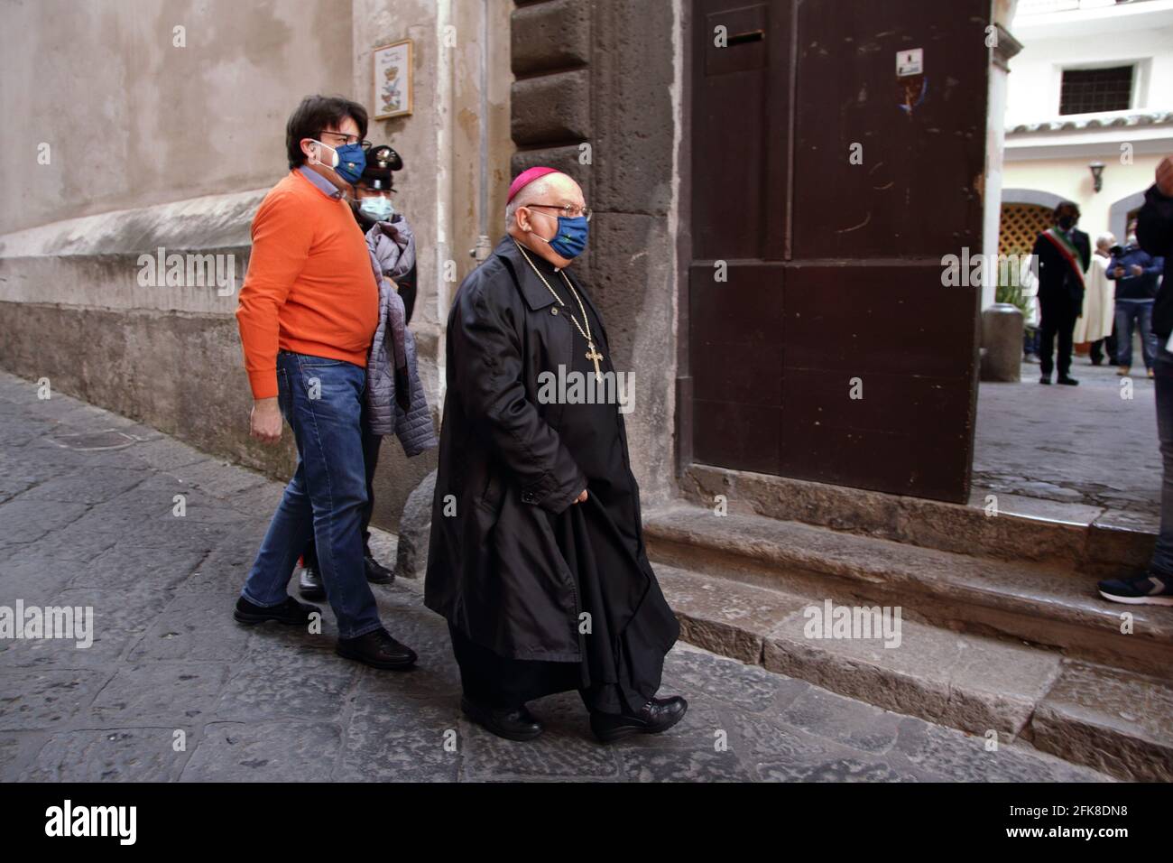The Bishop of the Diocese Nocera-Sarno with protective mask is entering the Sanctuary for the celebration of Holy Mass behind closed doors. Stock Photo