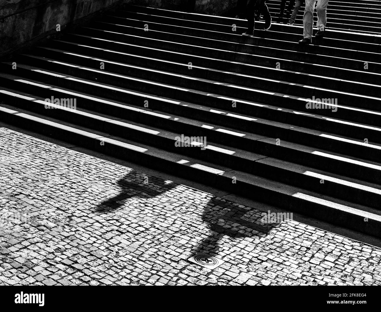 Shadow of two men walking down the staircase Stock Photo