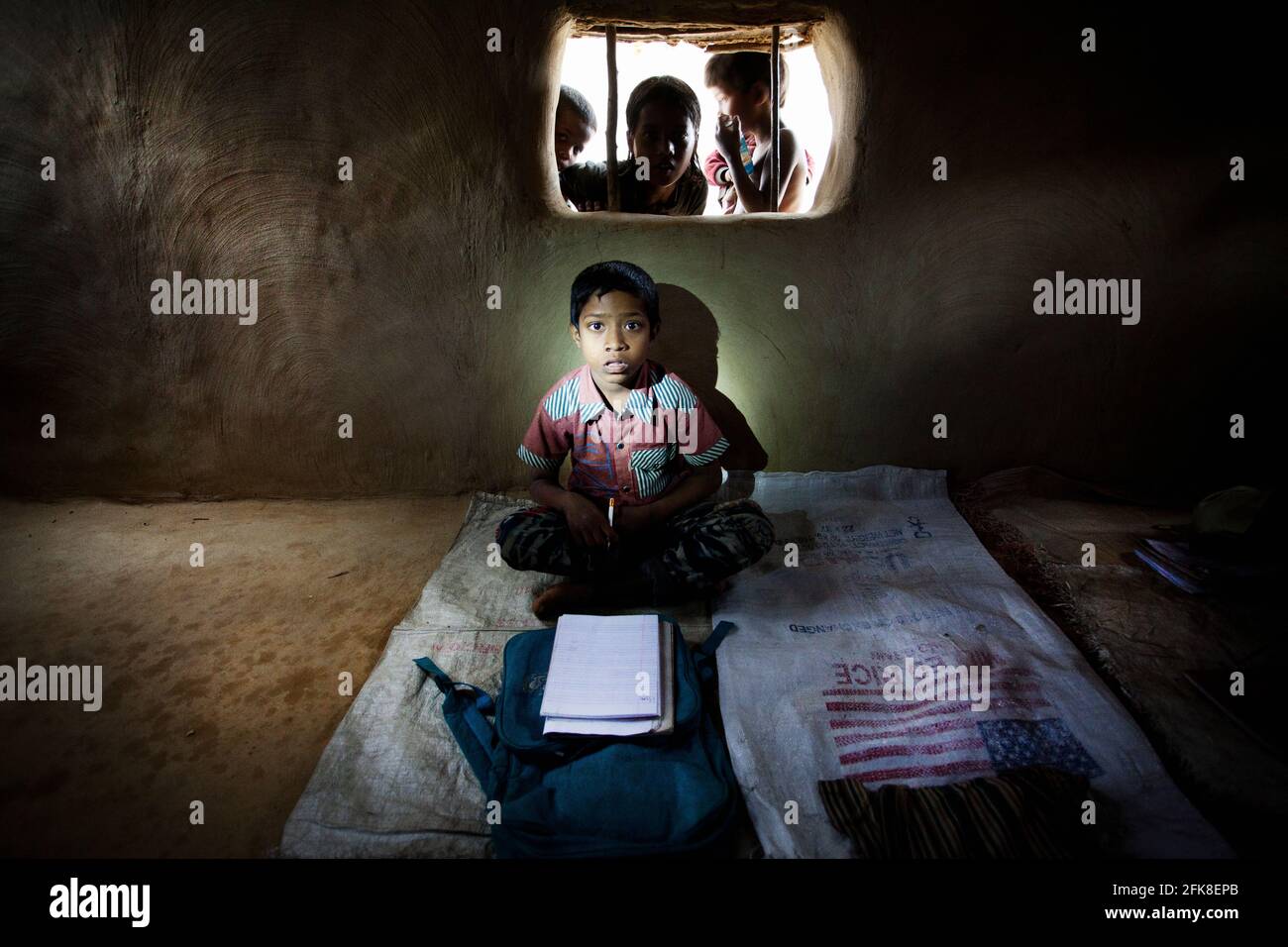 Young Rohingya refugee inside a little school made of mad in Kutupalong refugee camp, Bangladesh border Myanmar Stock Photo