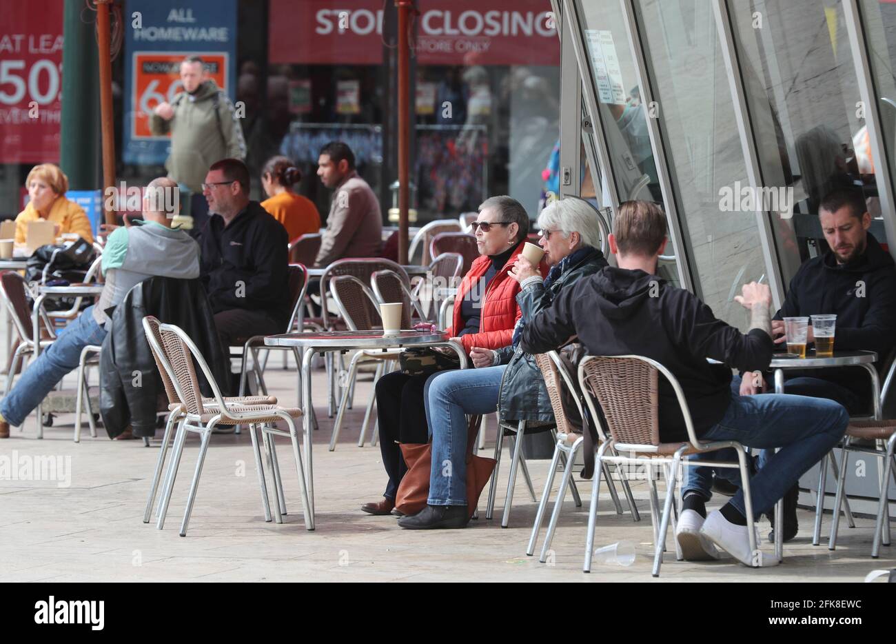 Bournemouth, UK. 29th April 2021.   People enjoying a coffee at a cafe in Bournemouth square ahead of the Bank Holiday weekend. Credit: Richard Crease/Alamy Live News Stock Photo