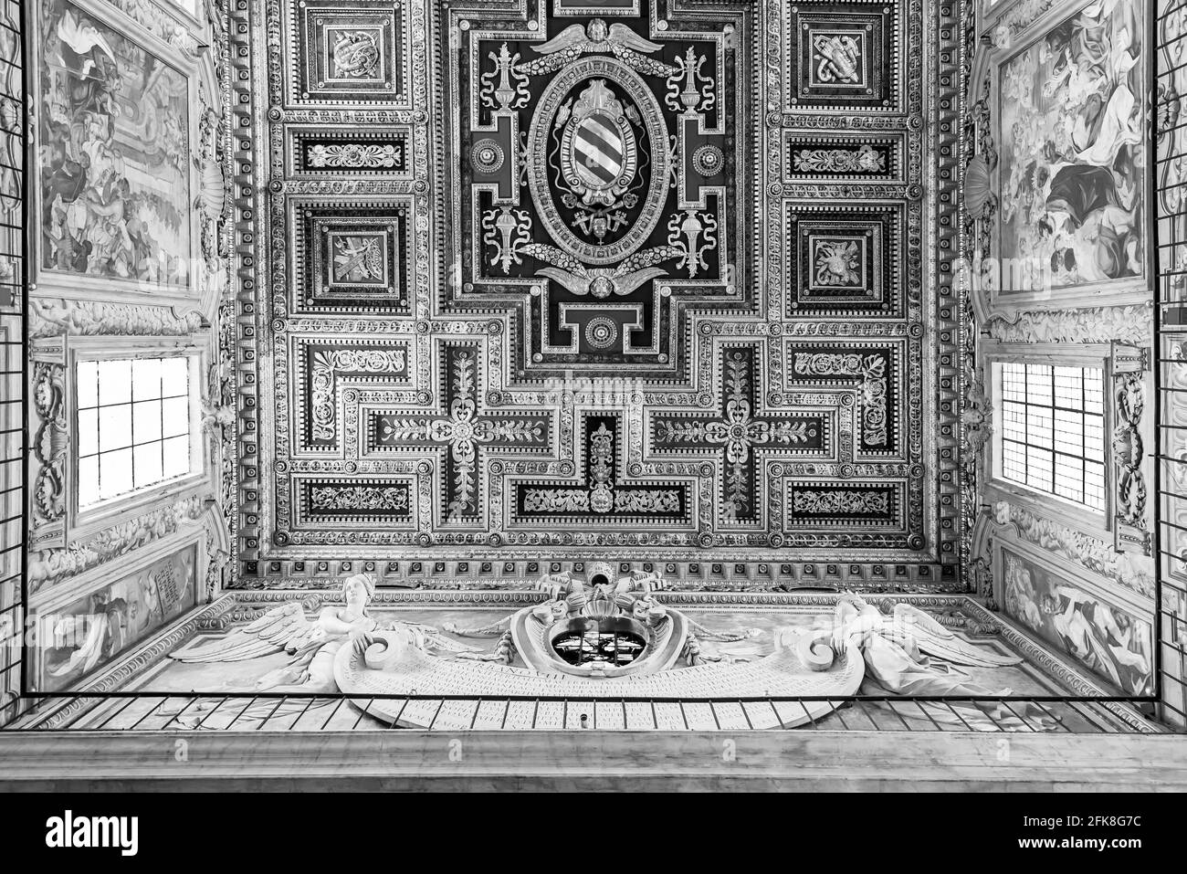 Black and white photo showing decorated wooden ceiling inside noble palace in Rome Stock Photo