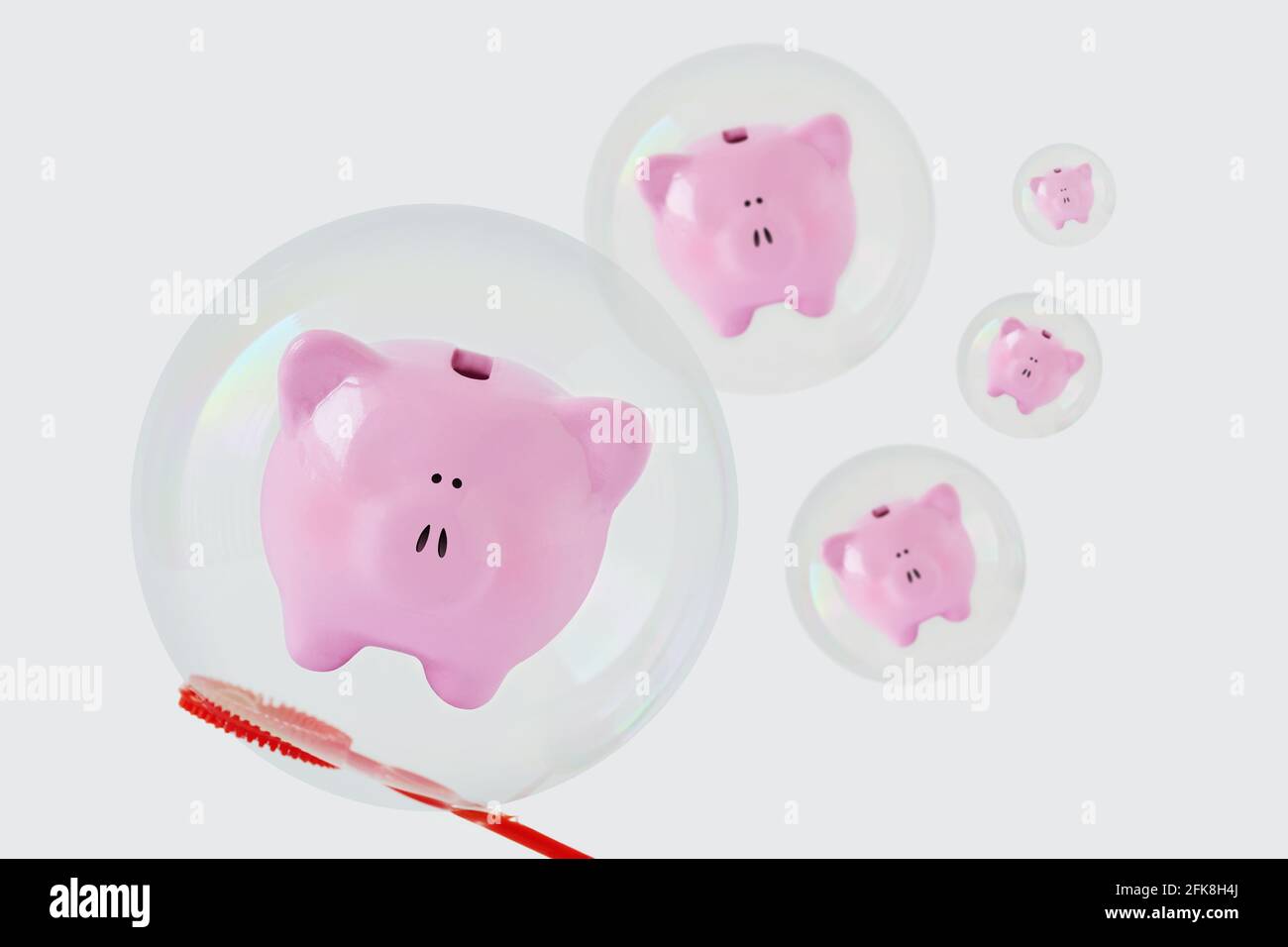 Piggy banks floating in soap bubbles  - Concept of savings and economic insecurity Stock Photo
