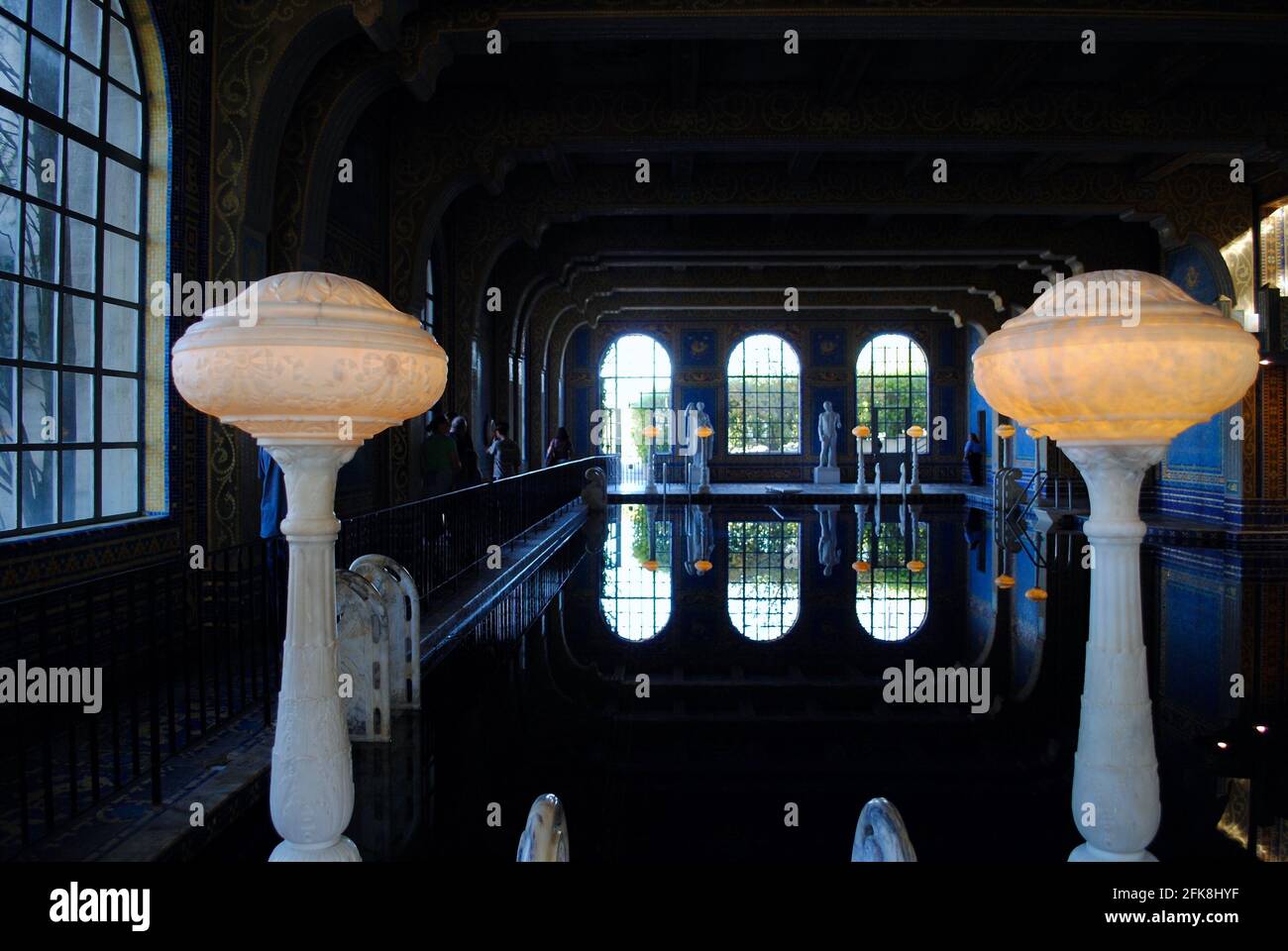 San Simeon, California: Hearst Castle indoor Roman pool with Murano glass and gold leaf tiles. Styled after an ancient Roman baths. Two lamps a Stock Photo