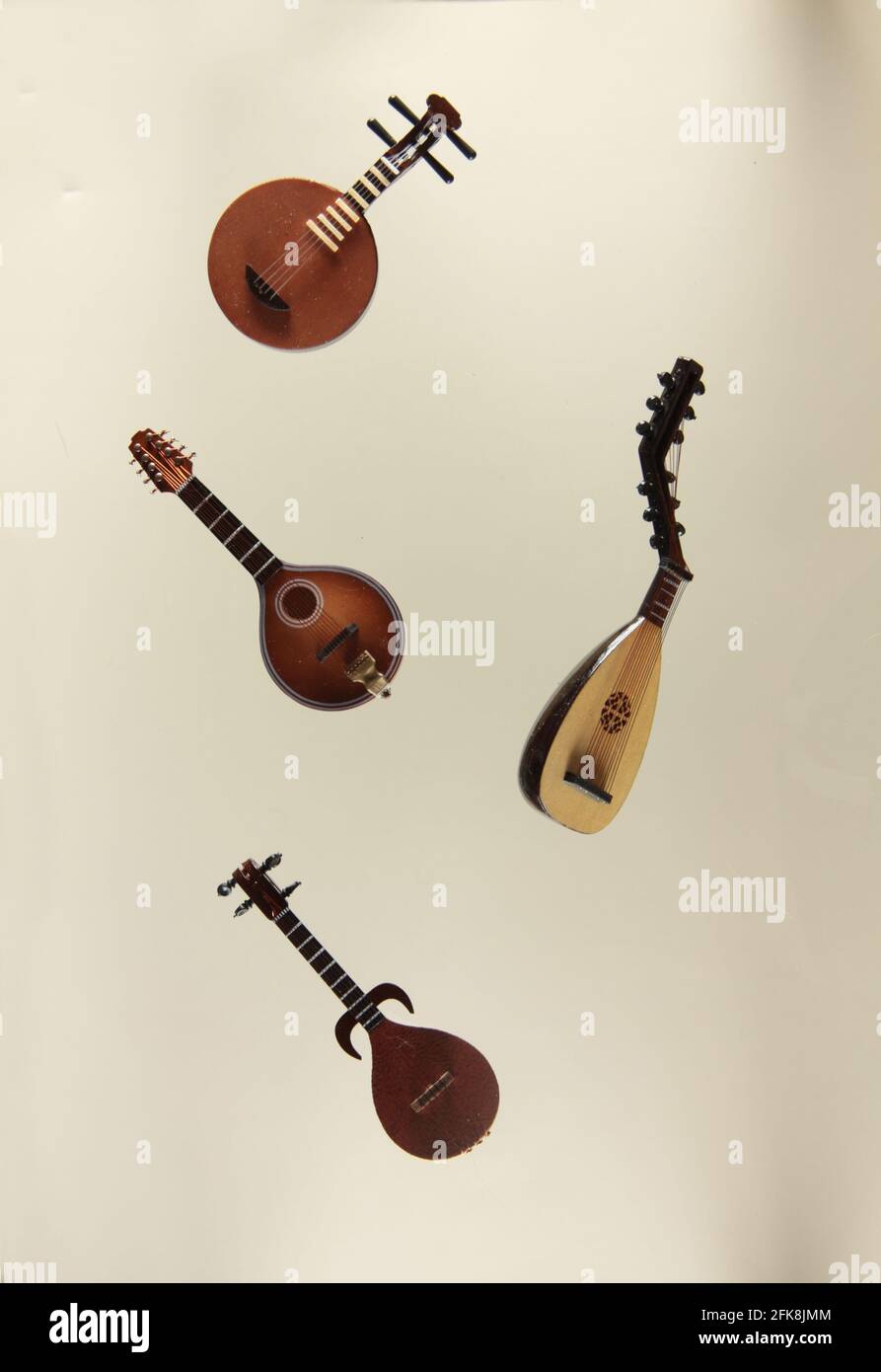 String instruments - rebab, theorbo, yueqin and mandoline isolated against light background. Image contains copy space Stock Photo