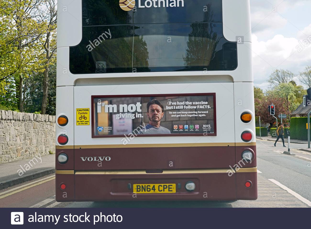 An Edinburgh Lothian Bus with messaging from the Scottish government re the Covid-19 vaccine, Edinburgh Scotland Stock Photo