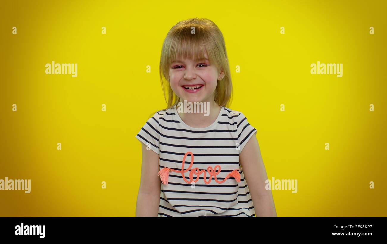 Smiling kid child laughing out loud after hearing ridiculous anecdote, funny joke, carefree amused Stock Photo