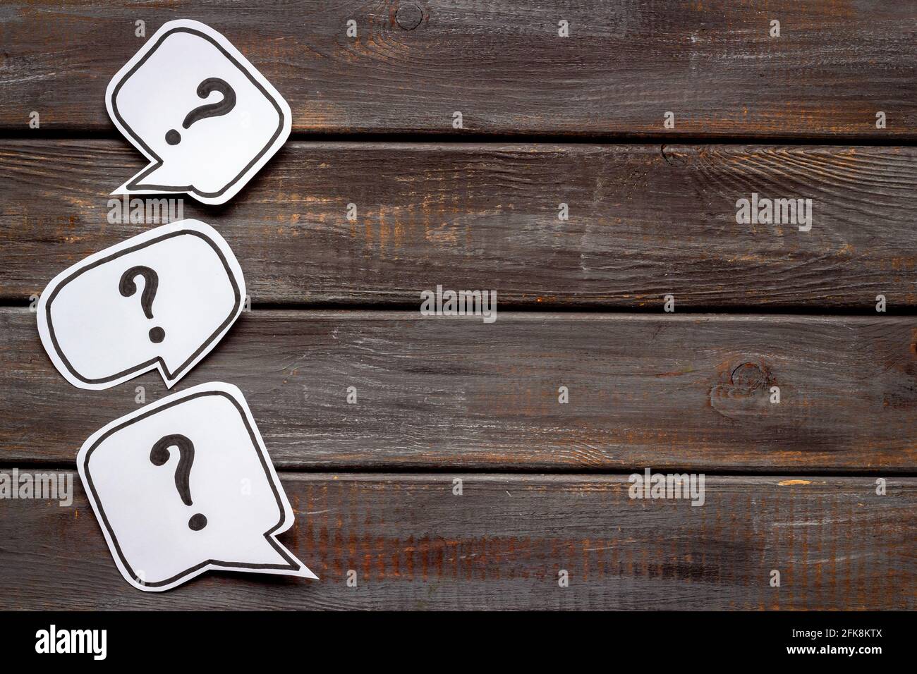 Ask question concept. Question mark on speech bubbles, top view Stock Photo